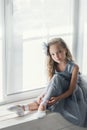 A little adorable young ballerina in a playful mood in the inter