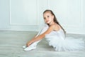 A little adorable young ballerina in a playful mood in the inter