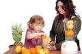 Little and adult girl made fruit juice Royalty Free Stock Photo