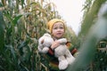 Little adventurer. Small kid with his friend toy taddy bear exploring nature together. Cute smiling toddler child playing in