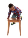 Little African-American boy climbing up stool on background. Danger at home Royalty Free Stock Photo