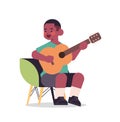 Little african american boy playing guitar childhood concept full length isolated Royalty Free Stock Photo