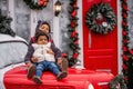 Little African American boy with sister girl sits on the hood Christmas vintage car. Children hugs Royalty Free Stock Photo