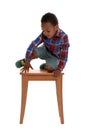 Little African-American  climbing up stool on white background. Danger at home Royalty Free Stock Photo