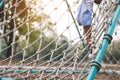 Little African American curly hair girl playing on park playground in spring or summer season. They enjoy climbing on the rope equ Royalty Free Stock Photo