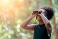 Little African American Girl with Binoculars during Hiking in Forest Royalty Free Stock Photo