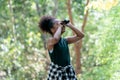 Little African American Girl with Binoculars during Hiking in Forest Royalty Free Stock Photo