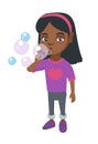 Little african-american girl blowing soap bubbles. Royalty Free Stock Photo