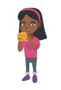 Little african-american girl eating a hamburger.