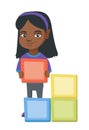 Little african girl playing with clourful cubes.