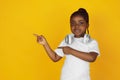 Little african-american girl`s portrait isolated on yellow studio background Royalty Free Stock Photo
