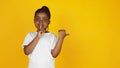 Little african-american girl`s portrait isolated on yellow studio background Royalty Free Stock Photo