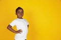 Little african-american girl`s portrait isolated on yellow studio background Royalty Free Stock Photo