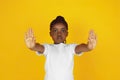 Little african-american girl`s portrait isolated on yellow studio background Royalty Free Stock Photo