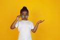 Little african-american girl`s portrait isolated on yellow studio background Royalty Free Stock Photo