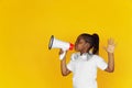 Little african-american girl`s portrait isolated on yellow studio background Royalty Free Stock Photo