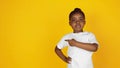 Little african-american girl`s portrait isolated on yellow studio background Royalty Free Stock Photo