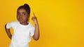 Little african-american girl`s portrait isolated on yellow studio background Royalty Free Stock Photo