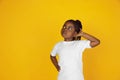 Little african-american girl`s portrait isolated on yellow studio background Royalty Free Stock Photo