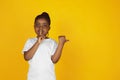 Little african-american girl`s portrait isolated on yellow studio background Royalty Free Stock Photo