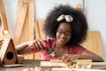 A little African American inventor practice to be a carpenter in carpentry shop