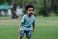 Little African American kid boy enjoy playing and running the park. Active child having fun with outdoor activity in summer Royalty Free Stock Photo