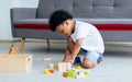 Little african cute boy sitting on the floor and playing toys in living room at home. Education and Lifestyle Concept Royalty Free Stock Photo