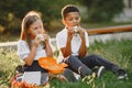 Little african boy take a breakfast with caucasian girl Royalty Free Stock Photo