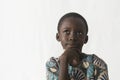 Little African boy thinking about his future, isolated on white Royalty Free Stock Photo