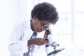 A little african boy using microscope in classroom at school Royalty Free Stock Photo
