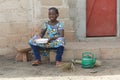 Little African Girl Cooking Rice Outdoors Smiling at Camera Royalty Free Stock Photo