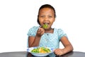 Little african girl eating healthy dish at table Royalty Free Stock Photo