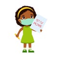 Little african girl with face mask holding paper sheet with `STAY HOME` sign