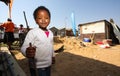 Little African Girl playing in the backyard building site in a Soweto Township