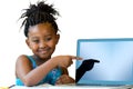 Little african girl pointing at blank laptop screen. Royalty Free Stock Photo