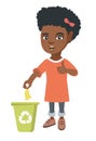 Little girl throwing banana peel in recycling bin.