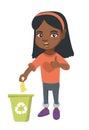 Little girl throwing banana peel in recycling bin.