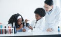 Little African kids studying chemistry and doing chemical science experiment in laboratory at school. Royalty Free Stock Photo