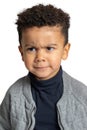 Little afro american boy frowning with angry facial expression Royalty Free Stock Photo