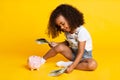 Little afro girl playing with money banknotes