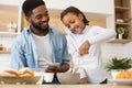 Cute little girl pouring milk into bowl with cereal Royalty Free Stock Photo