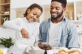 Adorable little girl pouring milk into bowl with cereal Royalty Free Stock Photo