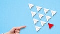 Little airplanes and a hand pointing to a red one symbolizing a different approach