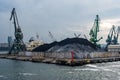 Little ammount of black coal in the sea port. Royalty Free Stock Photo