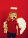 Little angel boy crying with white feather wings and halo Royalty Free Stock Photo