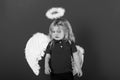 Little angel boy crying with white feather wings and halo Royalty Free Stock Photo