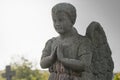 Little angel boy pray. Stone statue. concept children`s mortality Royalty Free Stock Photo