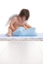 Little angel playing with pillows Royalty Free Stock Photo