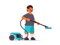 little arab boy using vacuum cleaner cleaning childhood concept full length horizontal