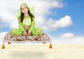 Little arabian girl sitting on flying carpet